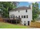 Back exterior of house with a large wooden deck and lush green grass at 2745 Saxon Drive, Duluth, GA 30096
