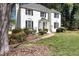 Beautiful white brick home with manicured lawn, shrubbery, and a welcoming walkway at 2745 Saxon Drive, Duluth, GA 30096