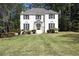 Charming two-story white brick home featuring black shutters and well-manicured landscaping at 2745 Saxon Drive, Duluth, GA 30096
