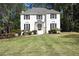 Charming two-story white brick home featuring black shutters and well-manicured landscaping at 2745 Saxon Drive, Duluth, GA 30096