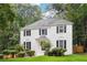 Beautiful two-story white brick home featuring black shutters and a professionally landscaped front yard at 2745 Saxon Drive, Duluth, GA 30096