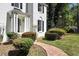 Close up of white brick home featuring decorative shrubbery and a welcoming walkway at 2745 Saxon Drive, Duluth, GA 30096