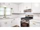 Modern kitchen design with stainless steel appliances, white cabinets and quartz countertops at 2745 Saxon Drive, Duluth, GA 30096