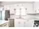 Updated kitchen with stainless steel appliances, quartz countertops, and subway tile backsplash at 2745 Saxon Drive, Duluth, GA 30096