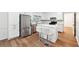 Modern kitchen with white cabinets, stainless steel appliances, and a white island with seating at 2745 Saxon Drive, Duluth, GA 30096