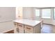Bright kitchen island with white cabinets, quartz countertop, and gold hardware at 2745 Saxon Drive, Duluth, GA 30096
