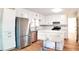 Spacious kitchen with stainless steel appliances, white cabinets, and a kitchen island with seating at 2745 Saxon Drive, Duluth, GA 30096