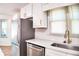 Modern kitchen with stainless steel appliances, white cabinets, and quartz countertops at 2745 Saxon Drive, Duluth, GA 30096