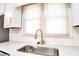 Kitchen sink with stainless steel basin, pull down faucet, and white quartz countertops at 2745 Saxon Drive, Duluth, GA 30096