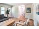 Bright living room with white trim, hardwood floors, and a cozy seating area with natural light at 2745 Saxon Drive, Duluth, GA 30096