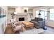 Bright living room with white brick fireplace, built-in shelving, and modern industrial lighting at 2745 Saxon Drive, Duluth, GA 30096