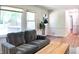Comfortable living area with a gray sofa, wood floors, and access to the outdoor deck at 2745 Saxon Drive, Duluth, GA 30096