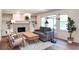 Bright living room with white brick fireplace, built-in shelving, and modern industrial lighting at 2745 Saxon Drive, Duluth, GA 30096