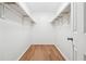Spacious walk-in closet features ample shelving and wood-look flooring at 2745 Saxon Drive, Duluth, GA 30096