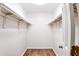 Walk in closet with installed rod and shelf, fresh paint and laminate floors at 2745 Saxon Drive, Duluth, GA 30096