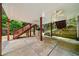 Open back patio area with overhead fans, concrete floors, and stairs leading up to backyard at 4715 Northridge Dr, Cumming, GA 30040