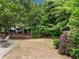 Spacious backyard with a wooden fence, mature trees, and a patio area with a hammock at 4715 Northridge Dr, Cumming, GA 30040