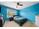Bedroom is painted in a blue color with a ceiling fan and window at 4715 Northridge Dr, Cumming, GA 30040