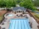 Aerial view of the community pool and clubhouse area, complete with lounge chairs and picnic tables at 4715 Northridge Dr, Cumming, GA 30040