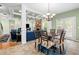 Stylish dining room with coffered ceilings, decorative chandelier, and views into living area at 4715 Northridge Dr, Cumming, GA 30040