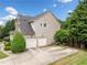 Home with a two-car garage, side yard, and driveway, nestled among mature trees at 4715 Northridge Dr, Cumming, GA 30040