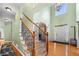 Grand foyer with hardwood floors, soaring ceilings, staircase with wood and iron railing, and arched doorway at 4715 Northridge Dr, Cumming, GA 30040