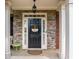 Charming front door with stone accents, welcome wreath, and overhead lighting at 4715 Northridge Dr, Cumming, GA 30040