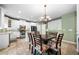 Bright kitchen features white cabinets, granite countertops, and an island with seating at 4715 Northridge Dr, Cumming, GA 30040