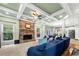 Cozy living room featuring a stone fireplace, coffered ceilings, and comfortable seating at 4715 Northridge Dr, Cumming, GA 30040