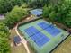 Aerial view of community tennis courts surrounded by lush greenery and trees at 4715 Northridge Dr, Cumming, GA 30040