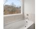 Close up on a tub with neutral tiling and hardware at 7169 Linden Dr, South Fulton, GA 30349