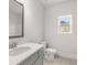 Bathroom featuring a vanity with a large mirror, toilet, and a window offering natural light at 7169 Linden Dr, South Fulton, GA 30349