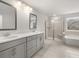 Bright bathroom featuring double vanity, shower, and separate tub at 7169 Linden Dr, South Fulton, GA 30349