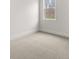 Bright bedroom with plush carpet, neutral walls, and a large window for natural light at 7169 Linden Dr, South Fulton, GA 30349