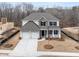 New two-story home boasts a symmetrical facade, attached two-car garage, and a well-manicured lawn at 7169 Linden Dr, South Fulton, GA 30349