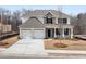 New two-story home with white brick, stone accents, and a two-car garage on a meticulously landscaped lot at 7169 Linden Dr, South Fulton, GA 30349
