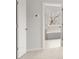 Hallway view towards bathroom with tile floor and neutral paint at 7169 Linden Dr, South Fulton, GA 30349