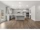 Spacious, open-concept kitchen with gray cabinets, a large island, stainless steel appliances, and hardwood floors at 7169 Linden Dr, South Fulton, GA 30349