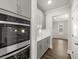 Gourmet kitchen showcases stainless steel double ovens, gray cabinetry, white countertops, and hardwood flooring at 7169 Linden Dr, South Fulton, GA 30349
