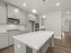 Bright kitchen featuring gray cabinetry, quartz countertops, stainless steel appliances, and a kitchen island at 7169 Linden Dr, South Fulton, GA 30349