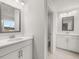 Bright bathroom with double sinks, white cabinetry, and tile flooring at 7171 Linden Dr, South Fulton, GA 30349