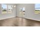 Bright dining area with hardwood floors, large windows, and french doors to the outside at 7171 Linden Dr, South Fulton, GA 30349