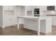 Island kitchen features white cabinets, quartz countertop, stainless steel appliances, and hardwood floors at 7171 Linden Dr, South Fulton, GA 30349