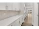 Kitchen featuring white countertops, tiled backsplash, stainless appliances, and hardwood floors at 7171 Linden Dr, South Fulton, GA 30349
