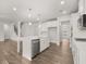 Open kitchen featuring island, white cabinets, hardwood floors, and stainless steel appliances at 7171 Linden Dr, South Fulton, GA 30349