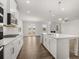 Open concept kitchen with large island, stainless appliances, stylish finishes, and hardwood floors at 7171 Linden Dr, South Fulton, GA 30349