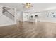 Open-concept living room and kitchen featuring hardwood floors, white cabinets and a center island at 7171 Linden Dr, South Fulton, GA 30349