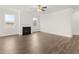 Spacious living room with a cozy fireplace, hardwood floors, and natural light at 7171 Linden Dr, South Fulton, GA 30349