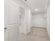 Spacious walk-in closet featuring carpeted flooring and white shelving at 7171 Linden Dr, South Fulton, GA 30349