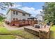 Spacious backyard featuring a large patio, deck, gazebo, and manicured landscaping at 3210 Avondale Pkwy, Powder Springs, GA 30127
